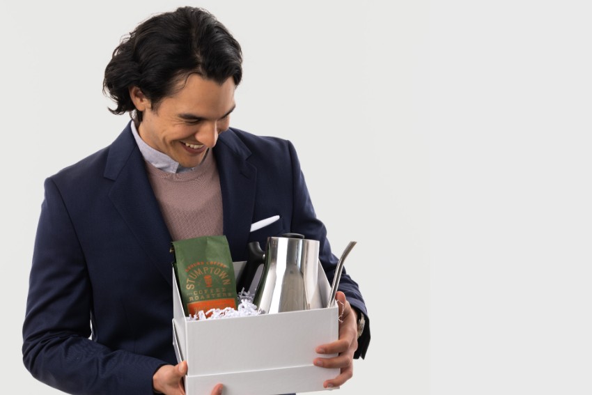 Man smiling holding a gift box